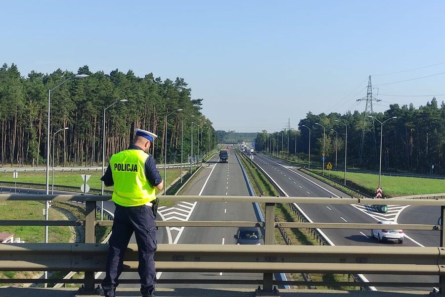 Policjant mierzący bezpieczną odległość między pojazdami na węźle Szczecin Dabie. Fot. Policja